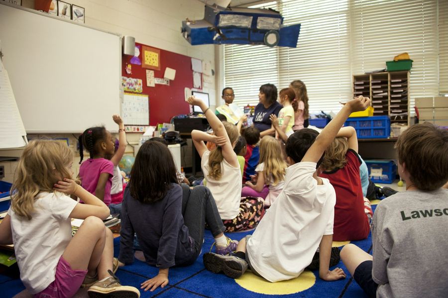Pupils sitting on the carpet during a primary lesson