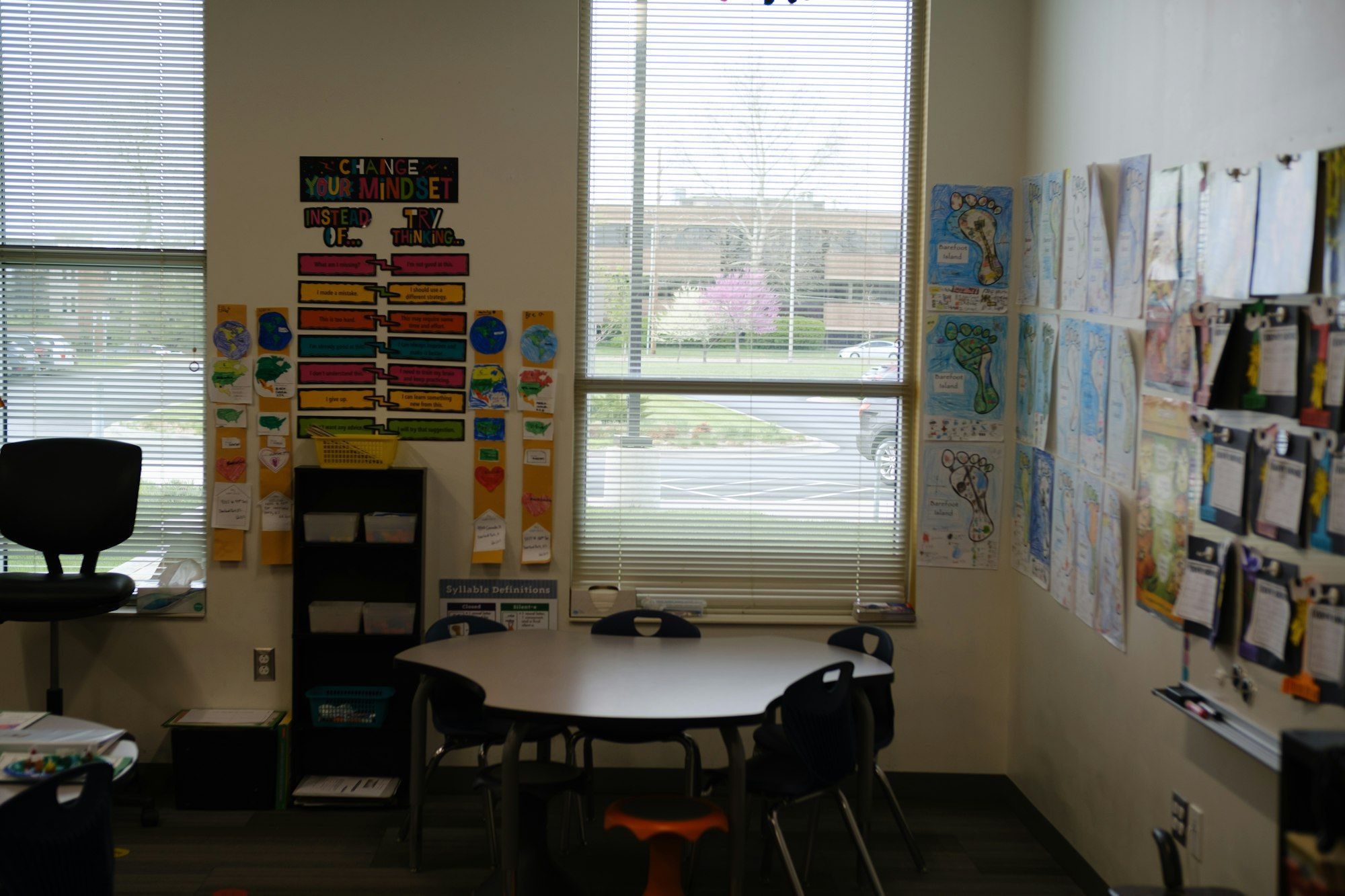 A bright, empty classroom corner with pupils' artwork on the walls