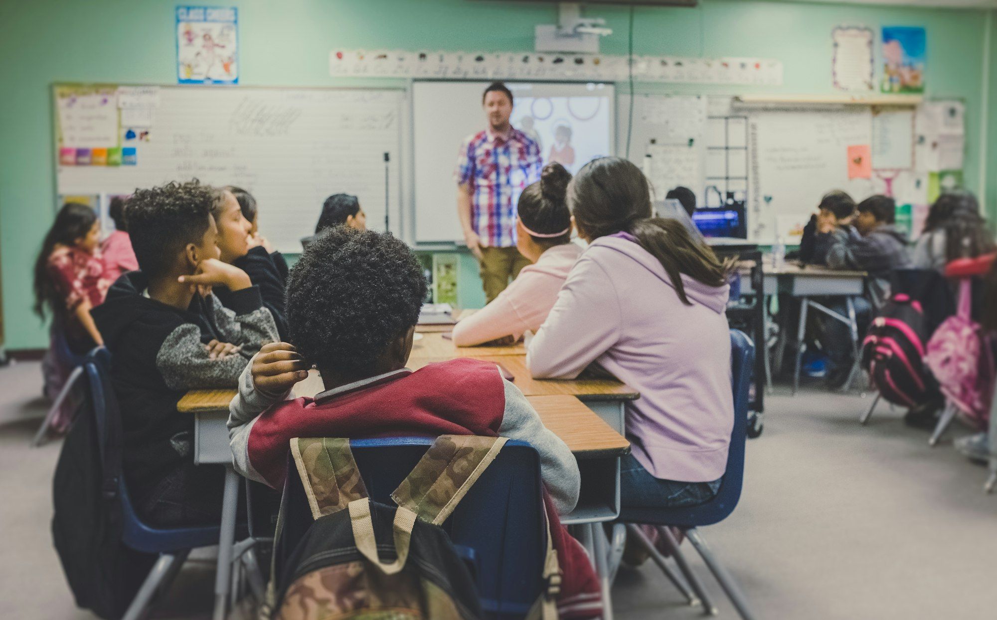 A teacher leading a lesson in a busy classroom