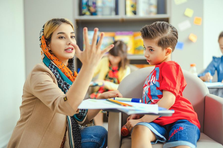 A teacher working one to one with a young pupil